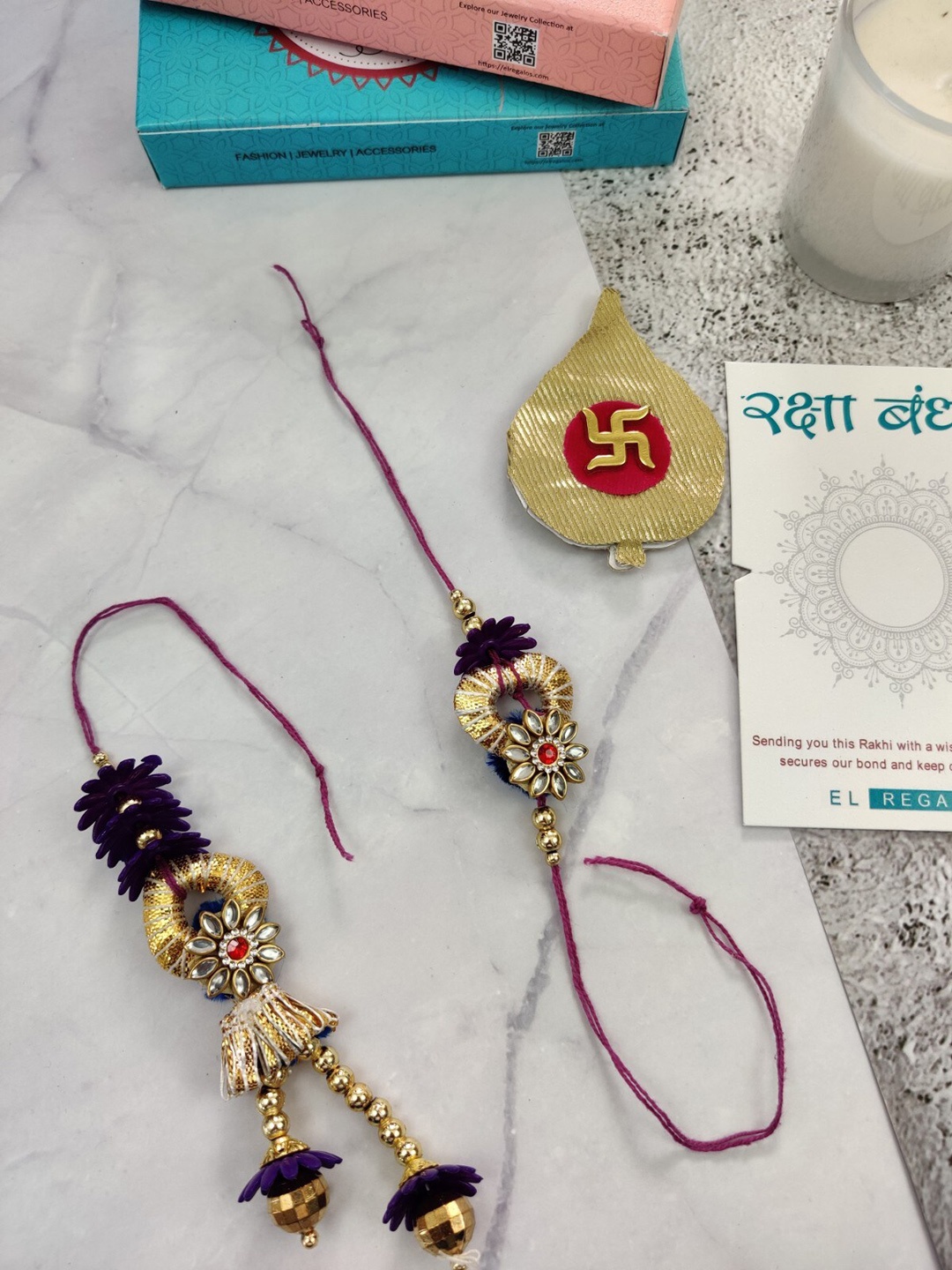 

EL REGALO Men Set Of 2 Flower Charm Rakhi With Candle & Greeting Card, Purple