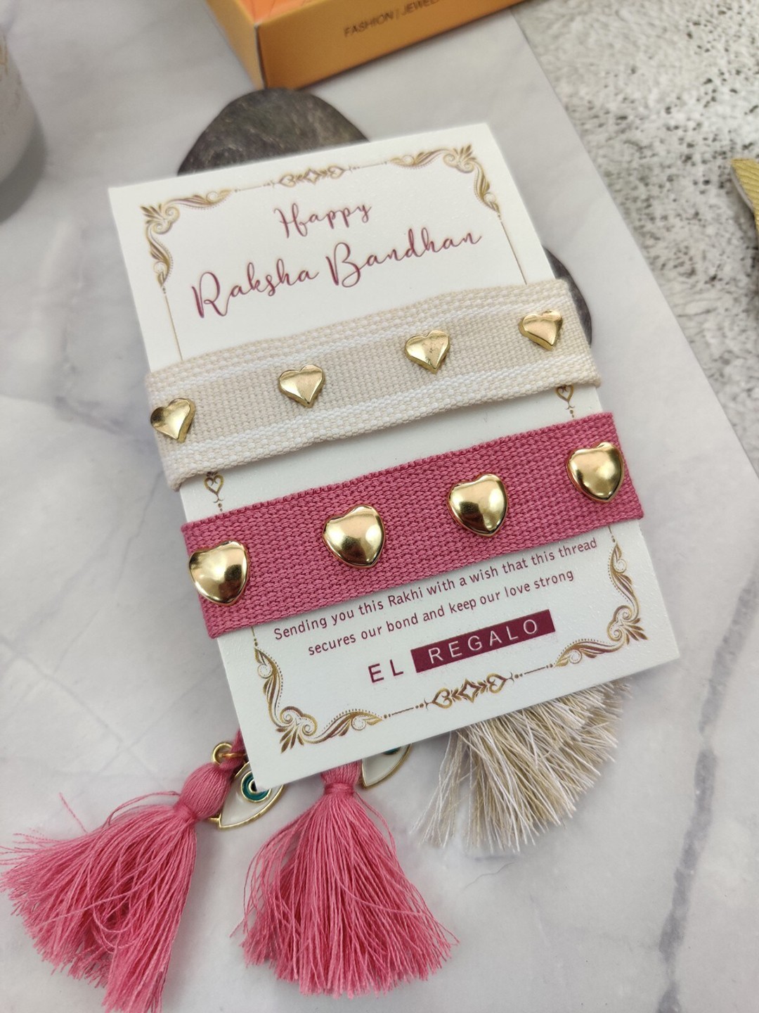 

EL REGALO Set Of 2 Heart Charm Rakhi With Candle & Greeting Card, Pink