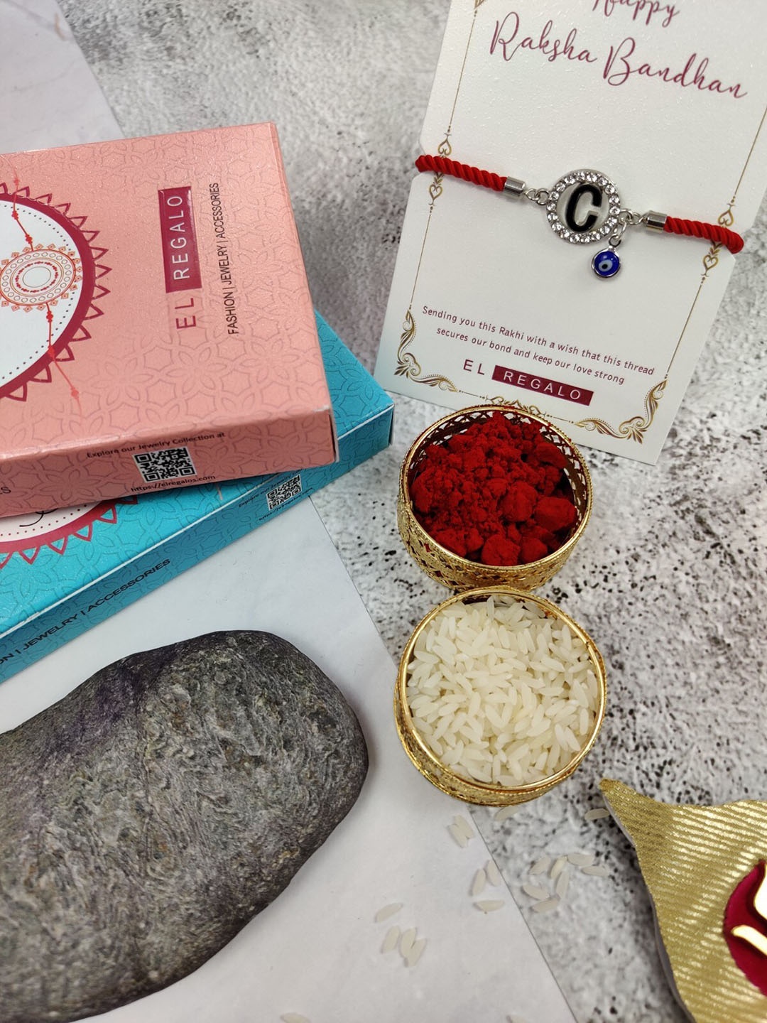 

EL REGALO C Letter & Evil Eye Charm Detail Rakhi With Roli Rice, Red