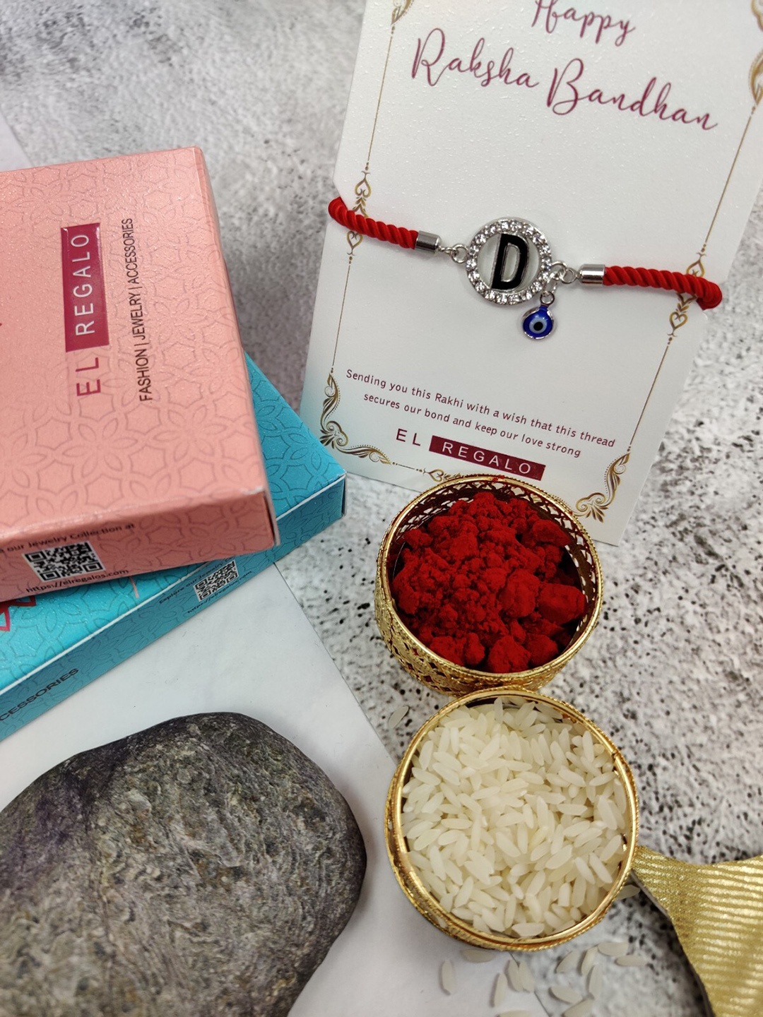 

EL REGALO D Name Initial Evil Eye Rakhi With Roli Chawal Card, Red