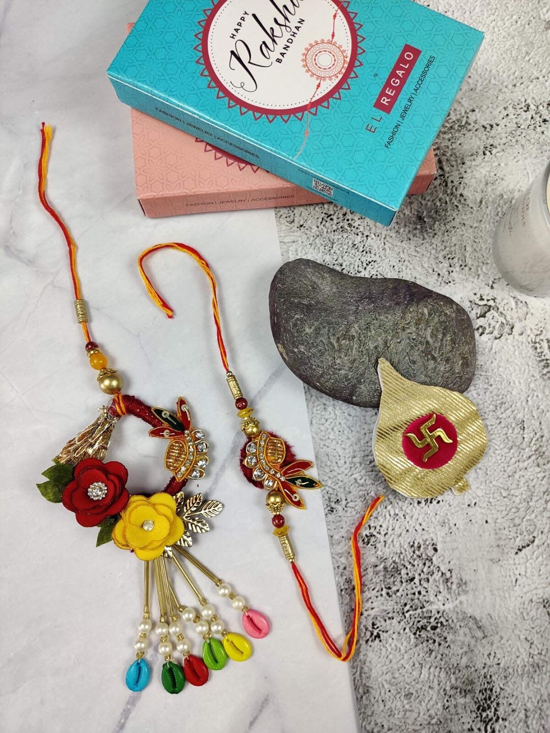 

EL REGALO Set Of 2 Stone Studded & Flower Charm Rakhi With Candle & Greeting Card, Red