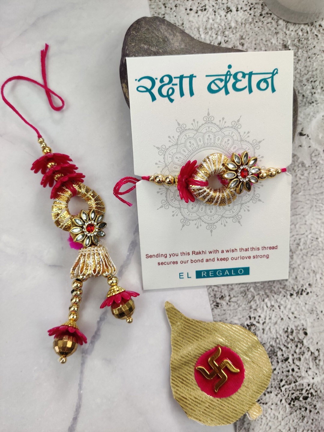 

EL REGALO Men Set Of 2 Flower Charm Rakhi With Candle & Greeting Card, Pink