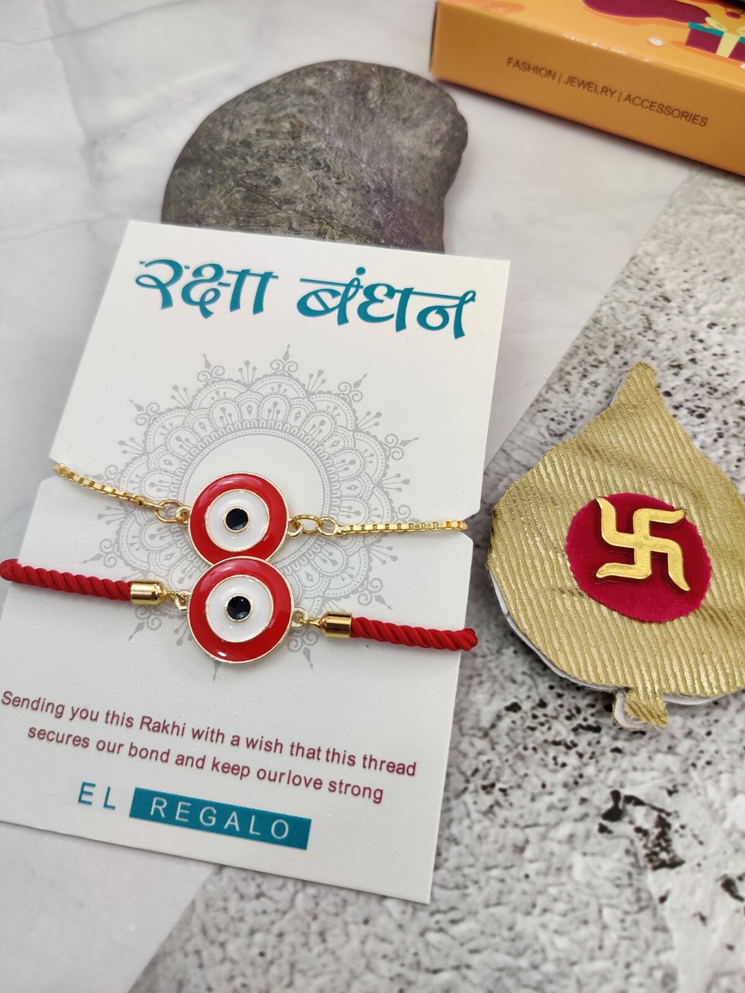 

EL REGALO Men Set Of 2 Evil Eye Charm Rakhi With Candle & Greeting Card, Red