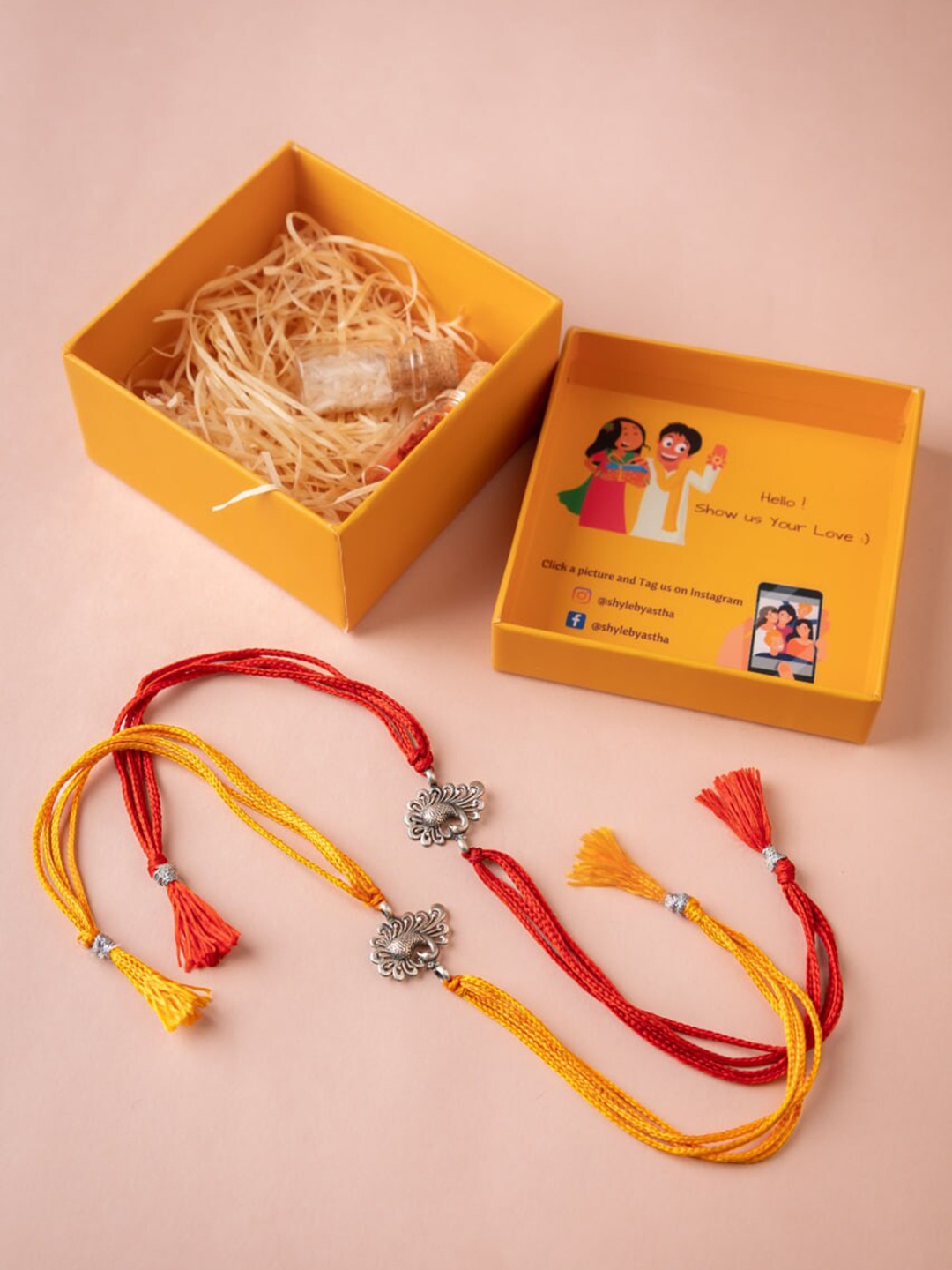 

Shyle Set Of 2 Dancing Peacock Thread Rakhis With Roli Chawal And Greeting Card, Silver