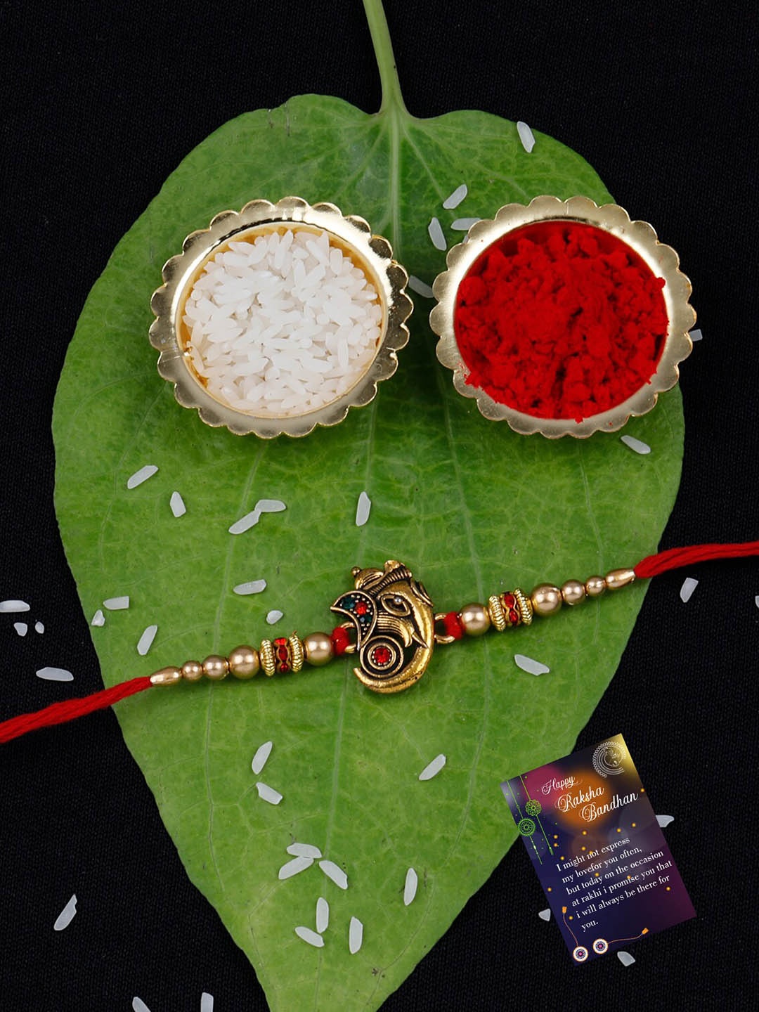 

Silver Shine Ganesha Charm Rakhi With Roli Chawal & Greeting Card, Gold