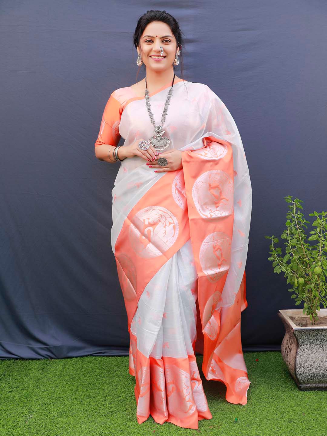 

Mitera Orange & Grey Ethnic Motifs Woven Design Zari Tissue Saree