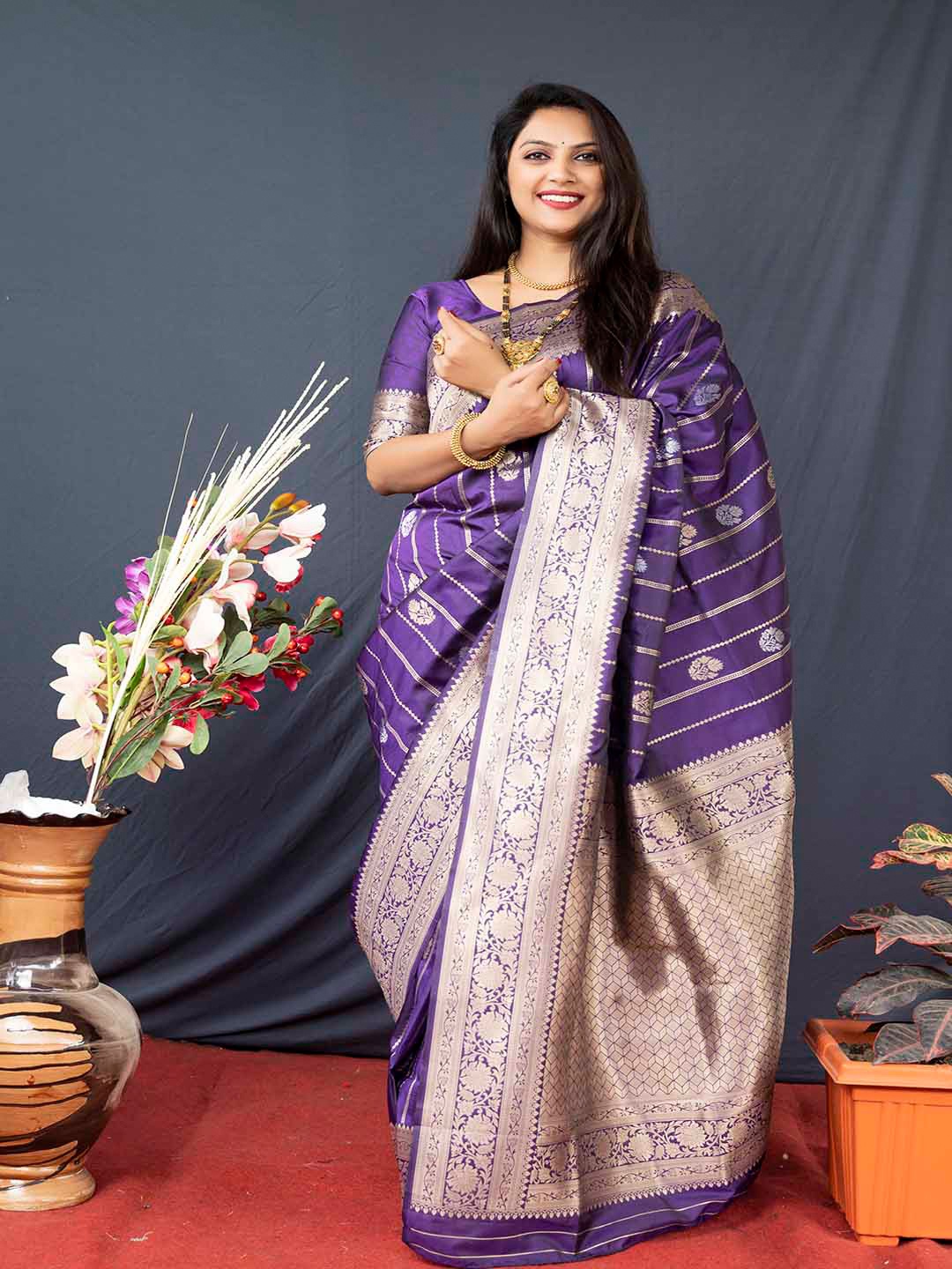 

Mitera Purple & Gold-Toned Ethnic Motifs Woven Design Zari Banarasi Saree