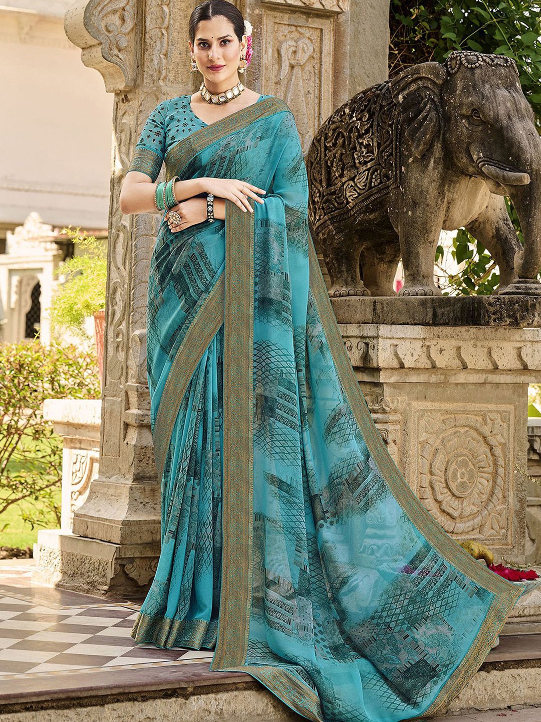 

Mitera Teal & Gold-Toned Ethnic Motifs Printed Zari Poly Georgette Saree