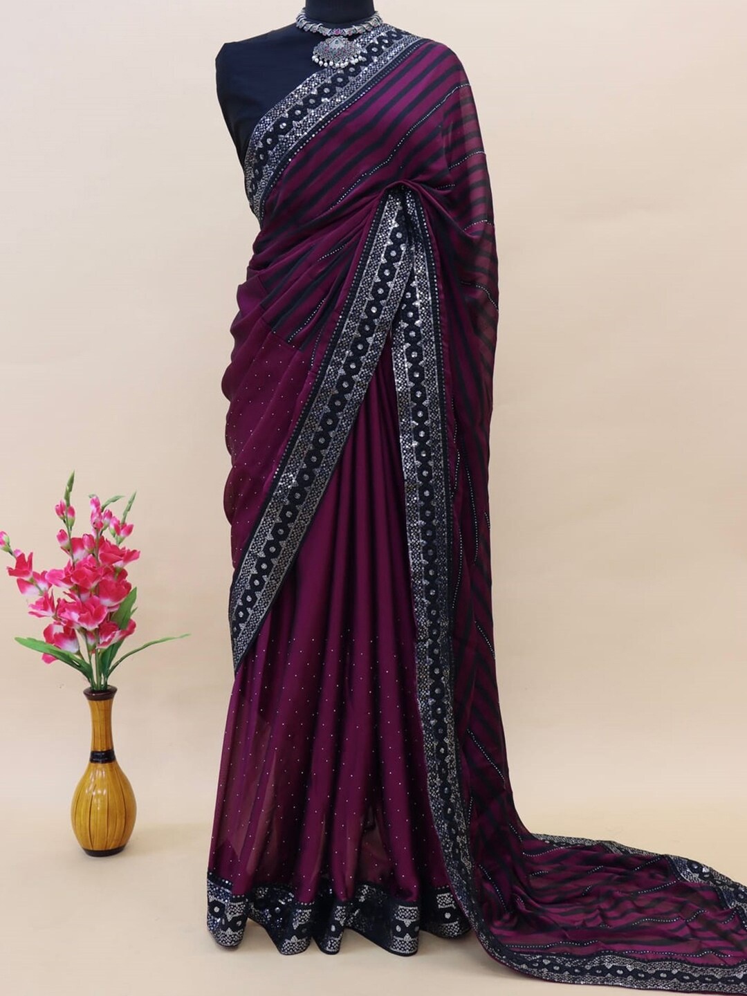 

Anouk Purple & Navy Blue Striped Embellished Sequined Pure Georgette Saree