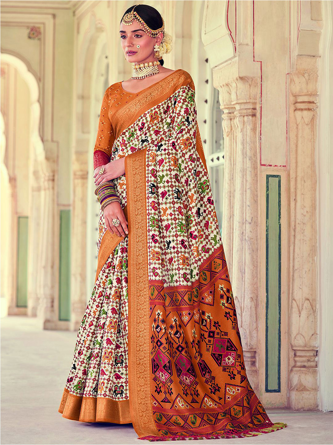 

Mitera Orange & White Ethnic Motifs Zari Silk Blend Patola Saree