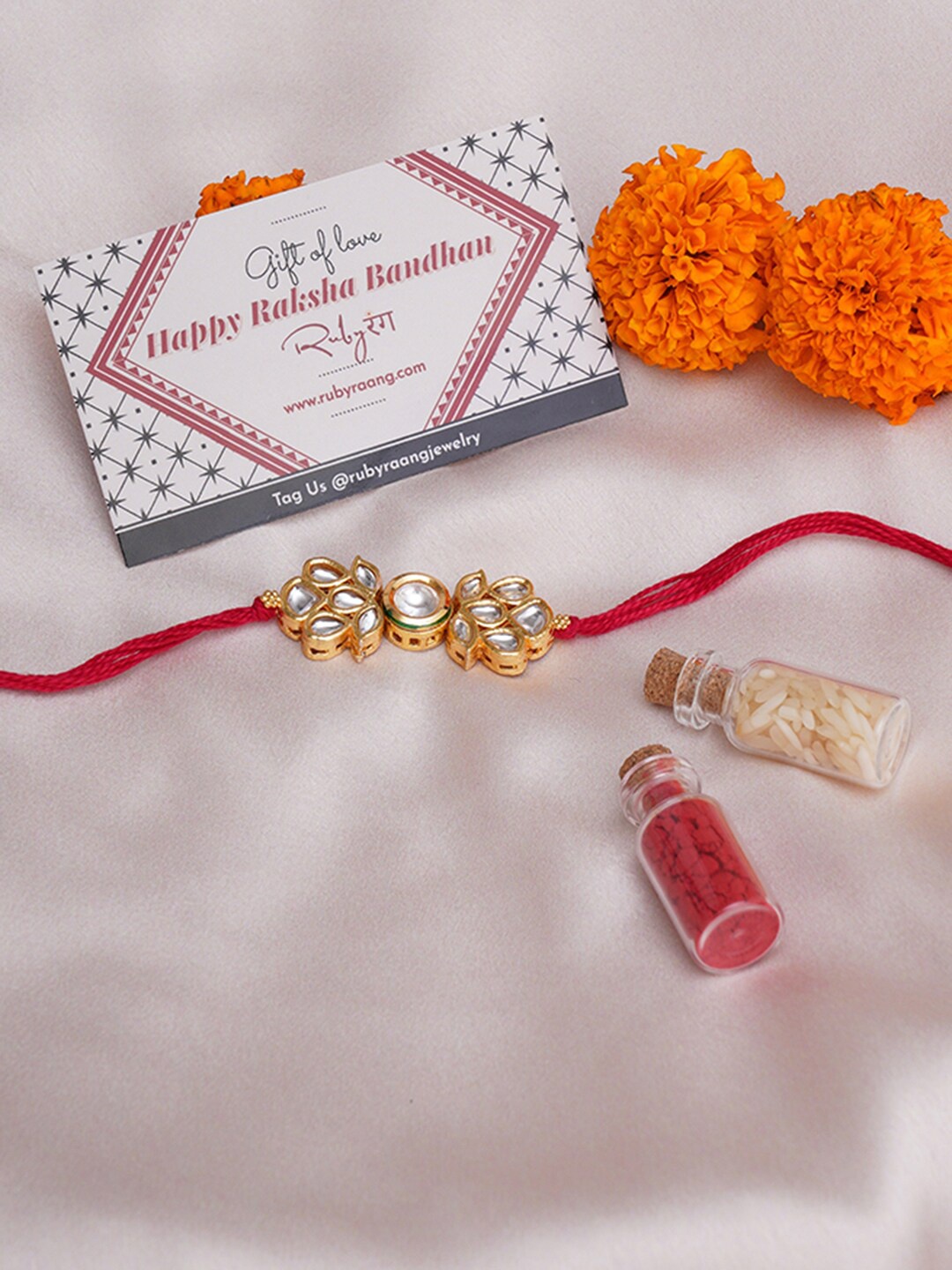 

Ruby Raang Stone-Studded Thread Rakhi With Roli Chawal & Greeting Card Gift Box, Gold