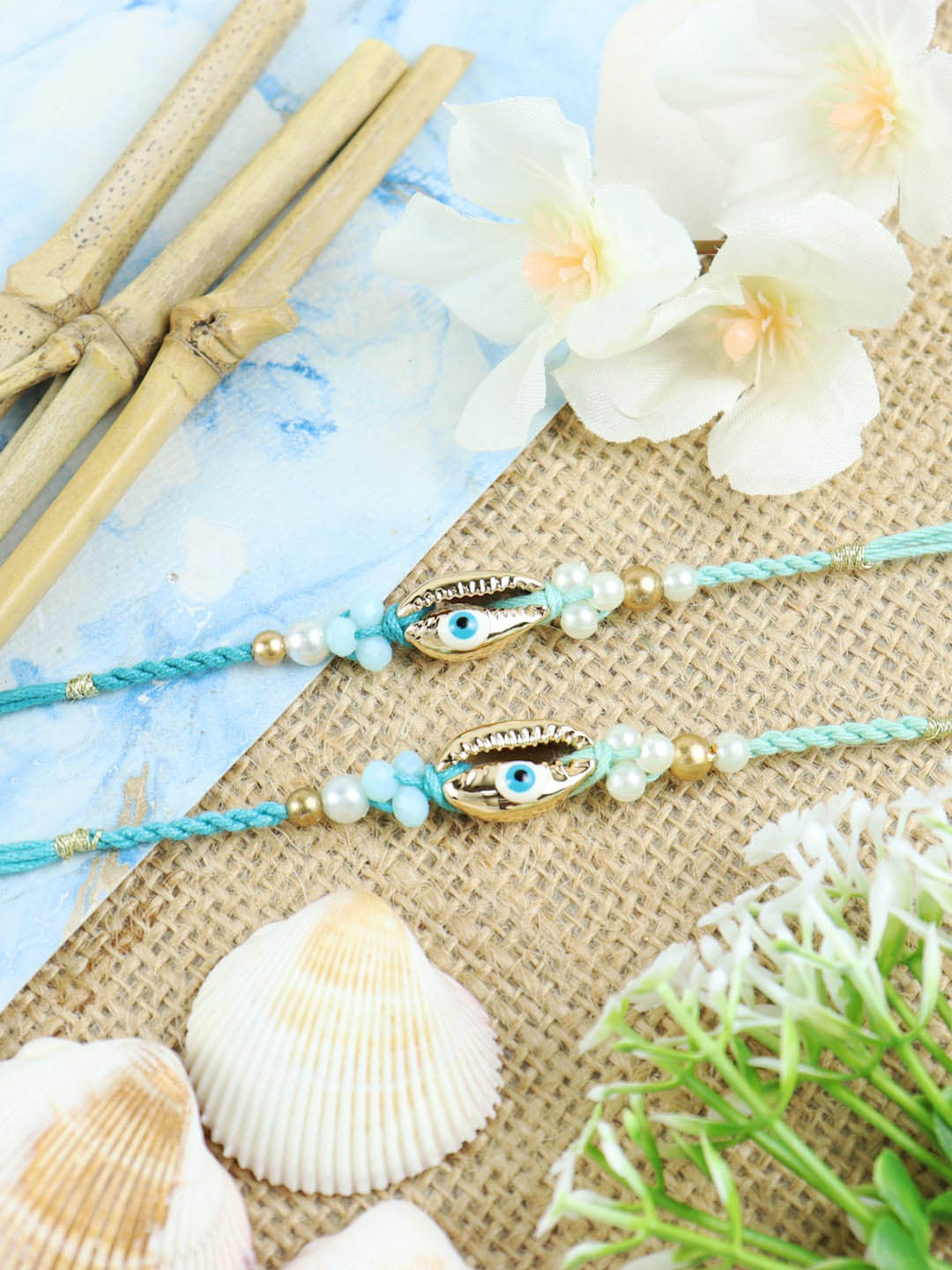 

Asthetika Men Set Of 2 Sea Shell Evil Eye Charm & Beaded Thread Rakhi, Blue