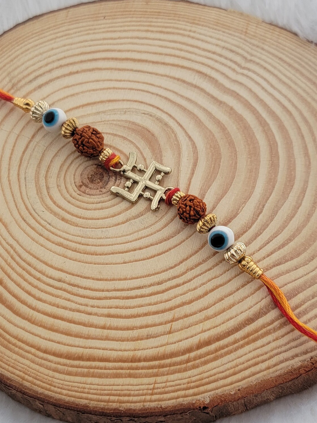 

Mahi Evil Eye & Swastik Charm Thread Rakhi, Gold