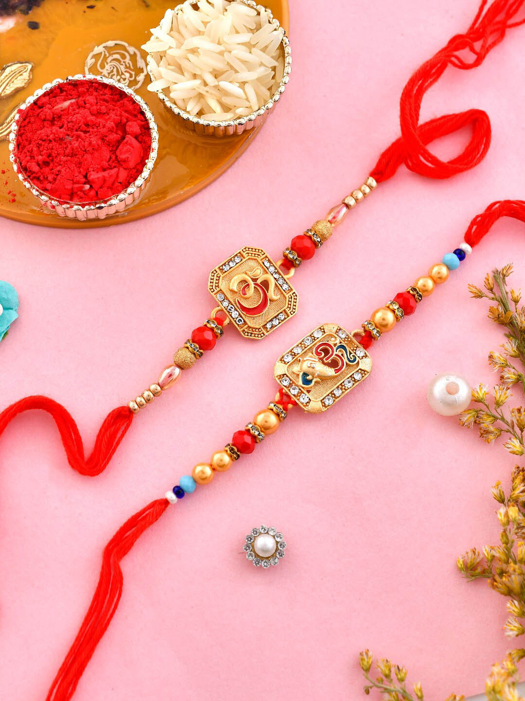 

Aapno Rajasthan Set Of 2 OM Charm Rakhi With Roli Chawal & Greeting Card, Gold