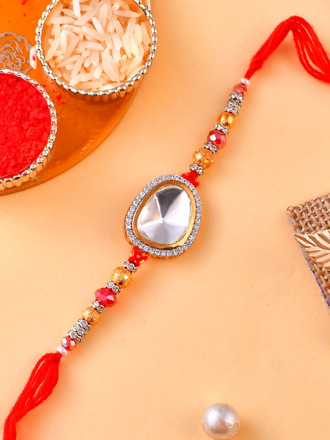 

Aapno Rajasthan Unisex Swarovski Studded Scarlet Rakhi With Card, Red