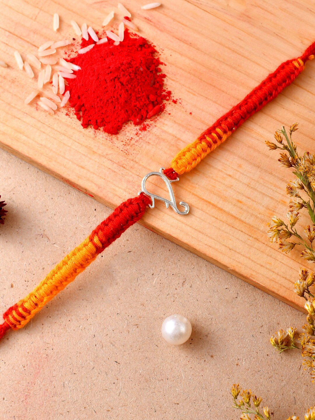 

Aapno Rajasthan Ganesha Charm Silver Rakhi with Roli Chawal