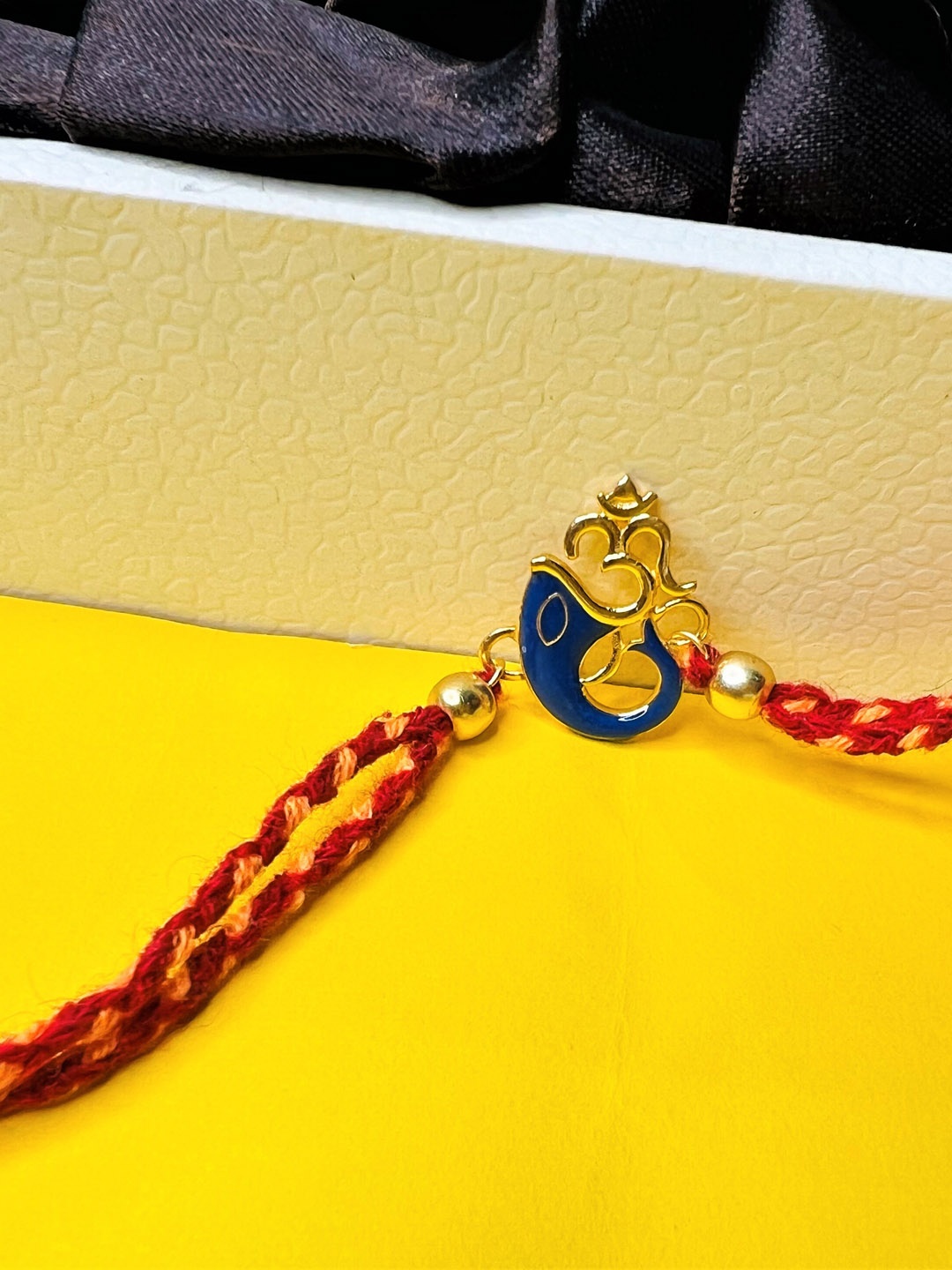 

Arte Jewels Om Ganesh Charm Thread Rakhi, Gold