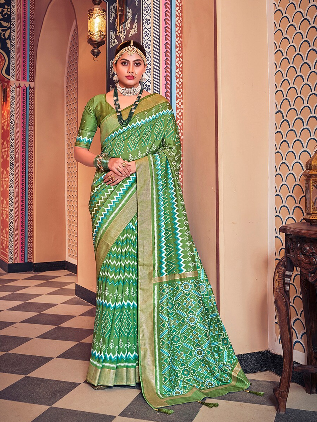 

Mitera Green Ethnic Motifs Printed Zari Silk Cotton Ikat Saree