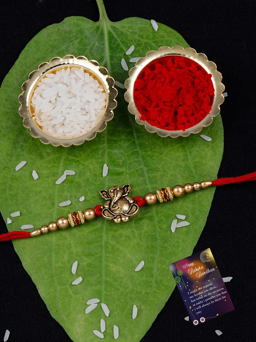 

Silver Shine Set Of 2 Stone & Ganesh Charm Rakhi With Roli Rice & Greeting Card, Red