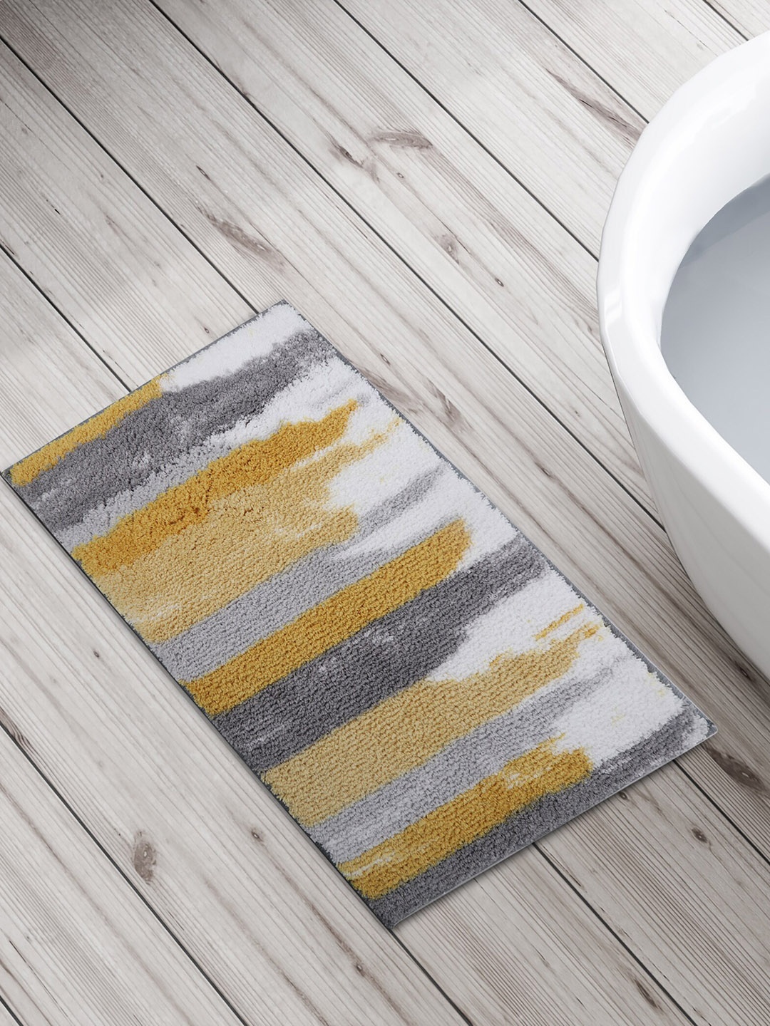 

Home Centre Yellow & White Printed Anti-Skid Bath Rug