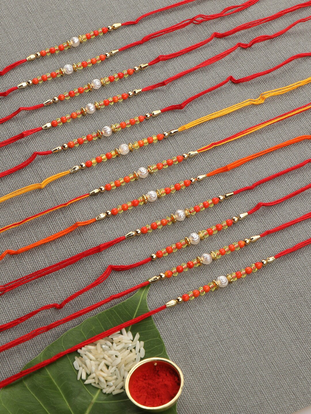 

AccessHer Set Of 12 Beaded Rakhis With Roli Rice & Greeting Card, Orange