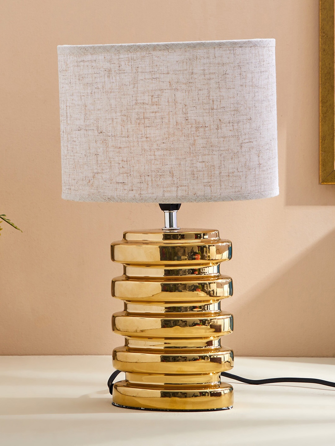 

Home Centre Tranquil Golden & Beige Ceramic Textured Table Lamp, Gold