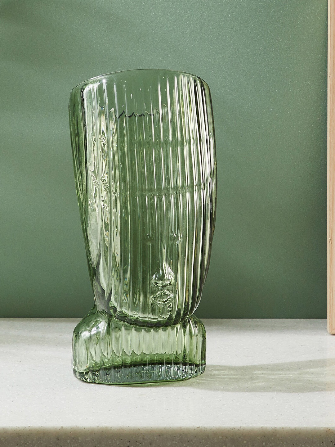 

Home Centre Brian Green Glass Face Shape Vase