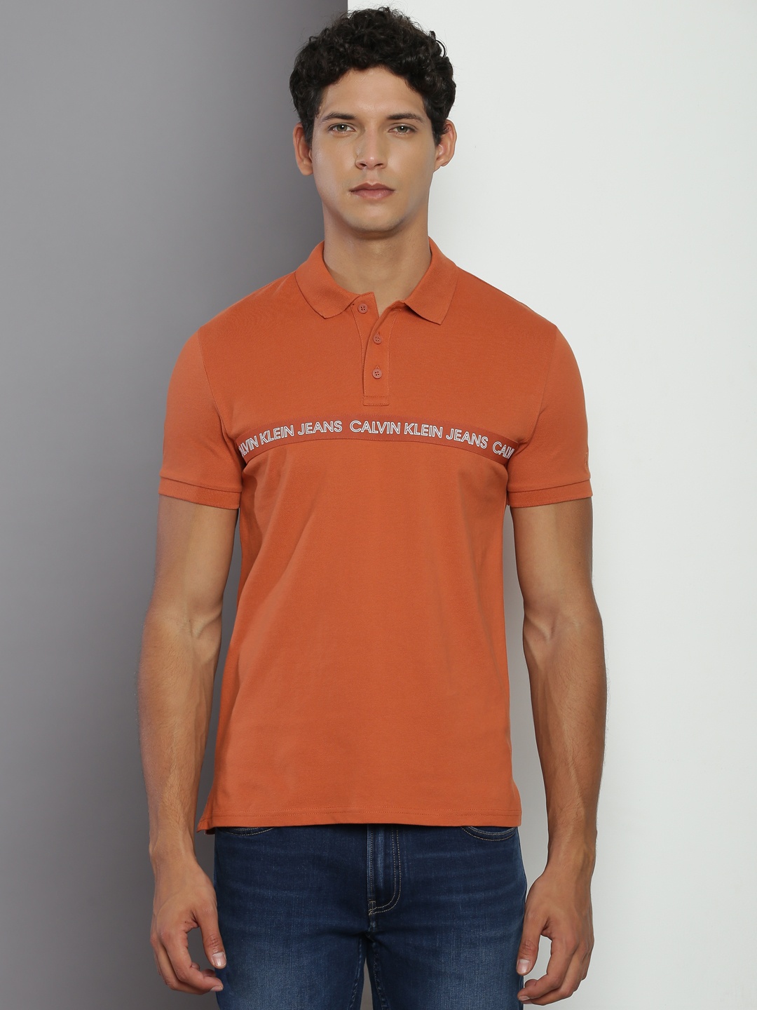 

Calvin Klein Jeans Typography Printed Polo Collar Slim Fit T-shirt, Rust