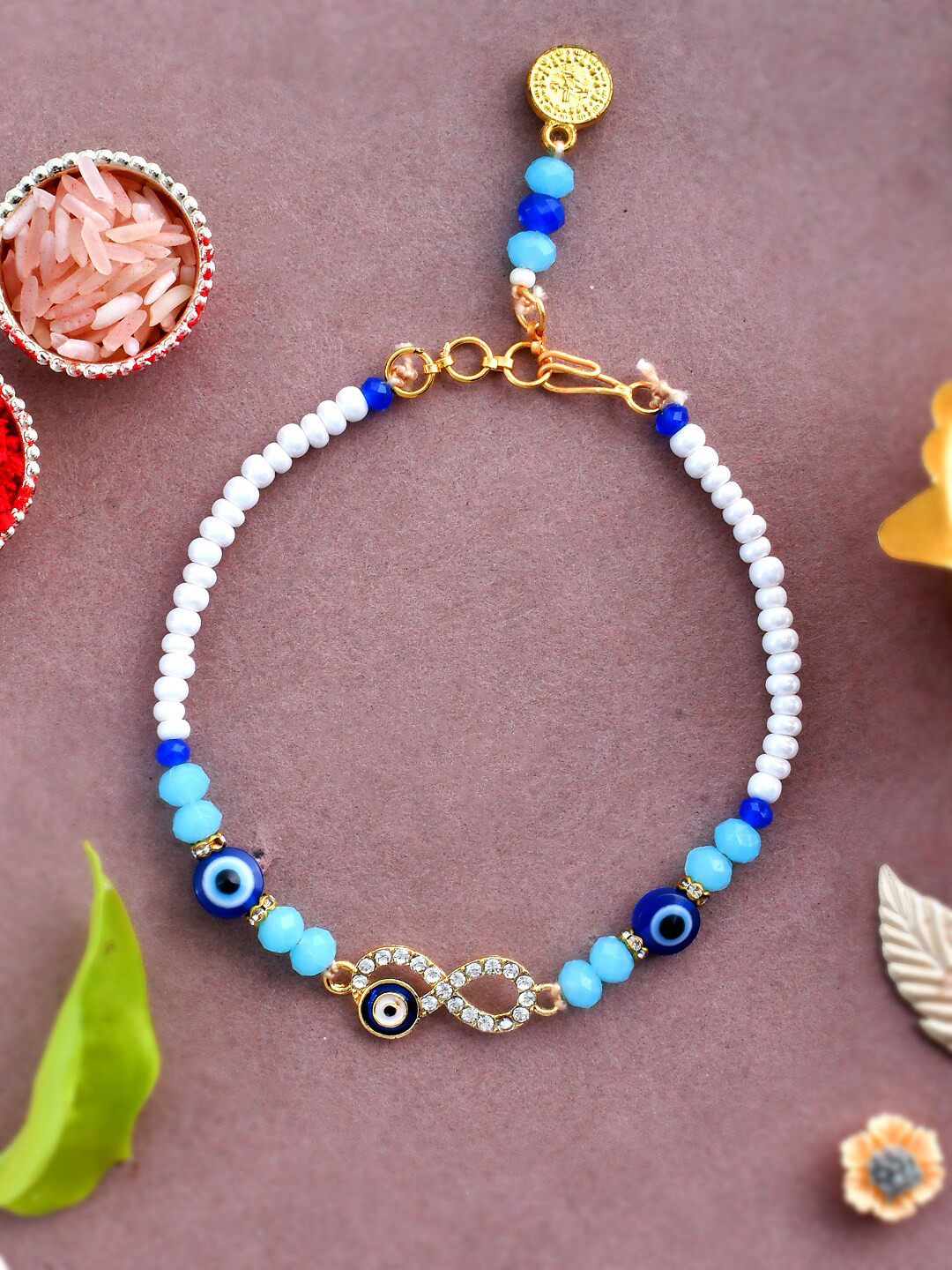 

Aapno Rajasthan Evil Eye Charm BraceletRakhi with Greeting Card Roli & Rice, Blue