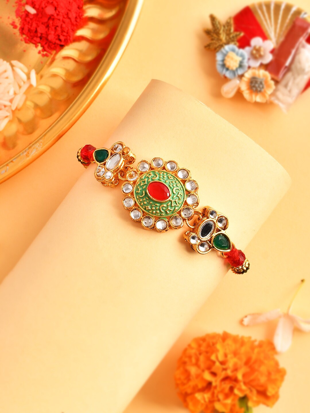 

Aapno Rajasthan Unisex Stone-Studded Flower Charm Beaded Rakhi, Gold