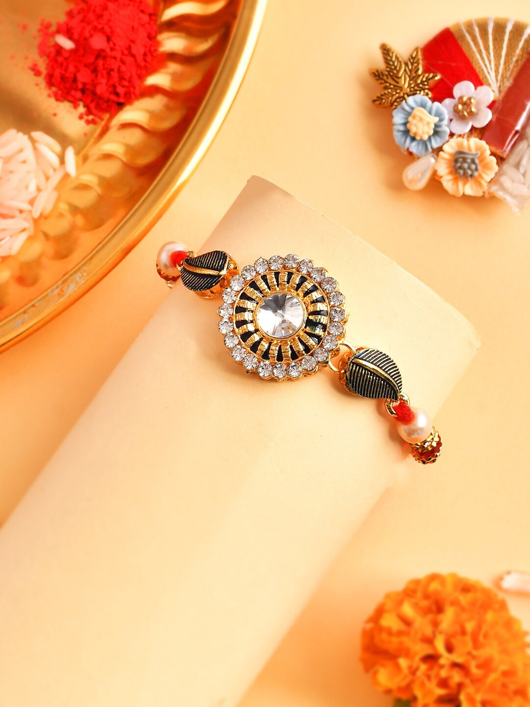 

Aapno Rajasthan AD Studded Rakhi With Greeting Card Roli & Rice, Gold