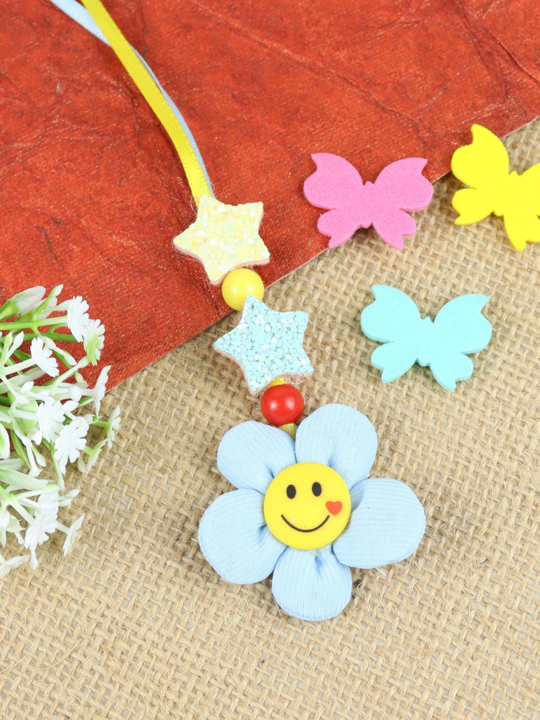 

Asthetika Girls Smiling Flower Charm Lumba Rakhi, Blue