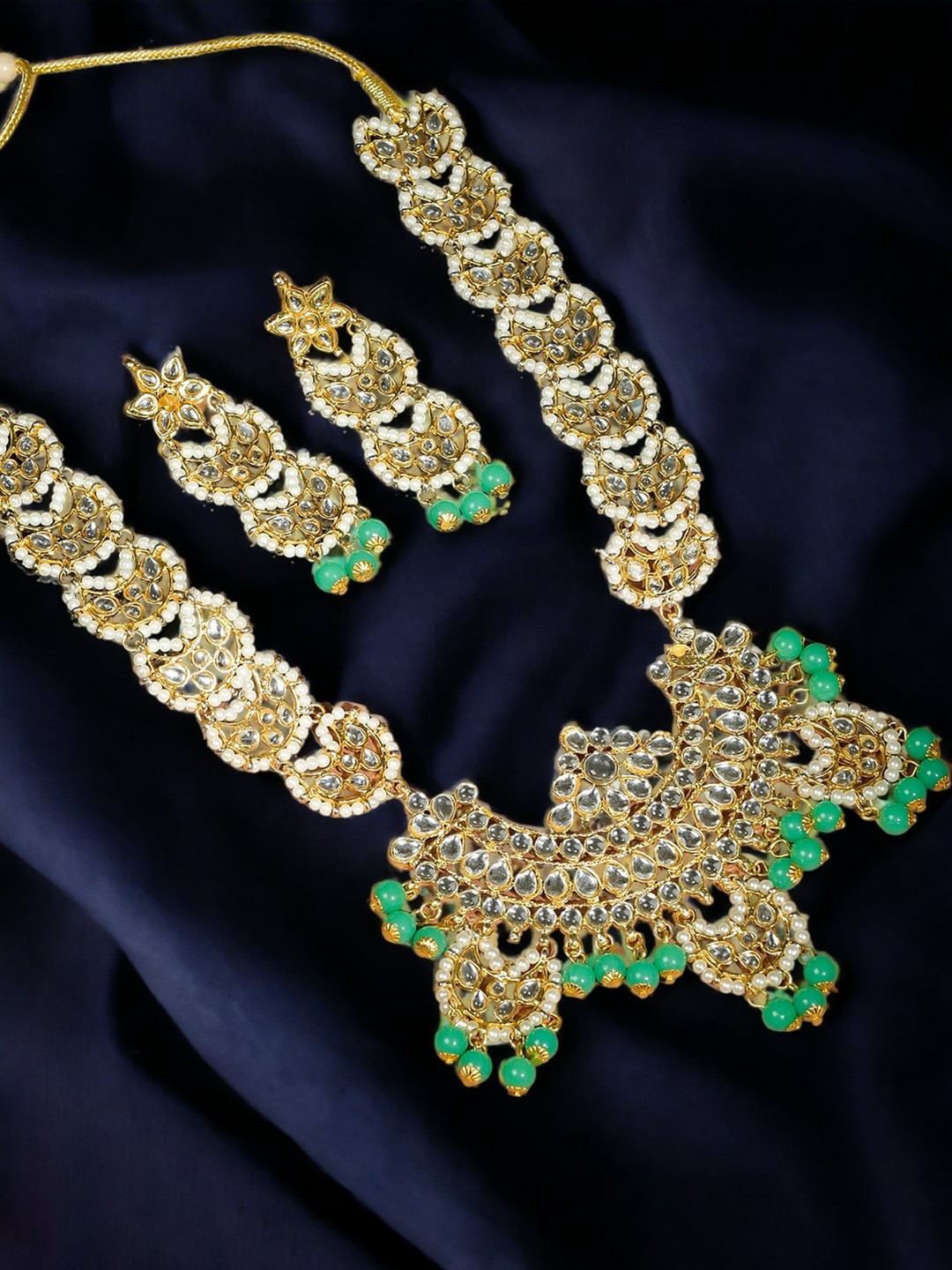 

Silvermerc Designs Gold Plated Kundan Studded & Beaded Jewellery Set