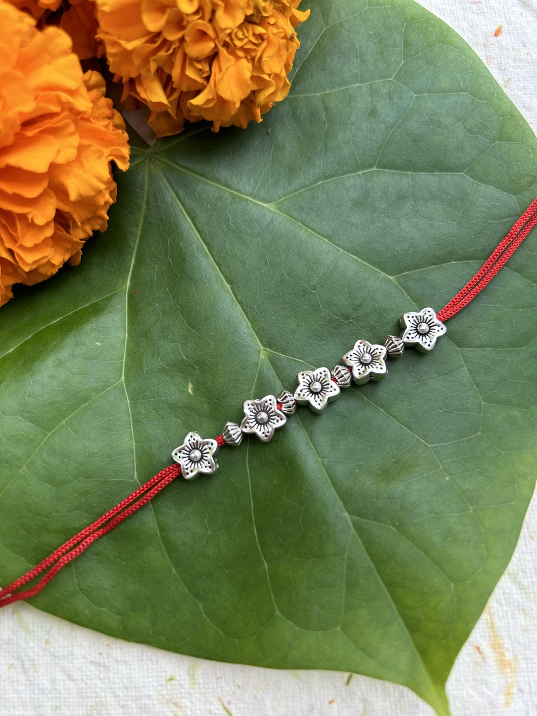 

FIROZA Men Amaryllis Sacred Rakhi, Silver
