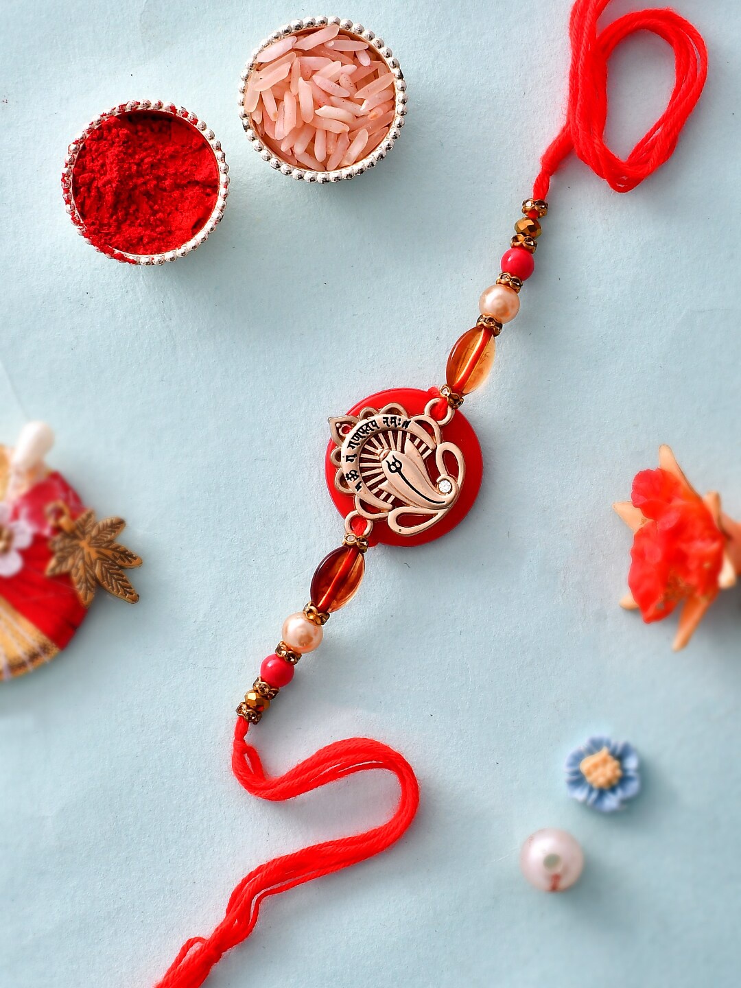 

Aapno Rajasthan Ganesha Charm Beaded Rakhi With Roli Rice & Greeting Card, Red
