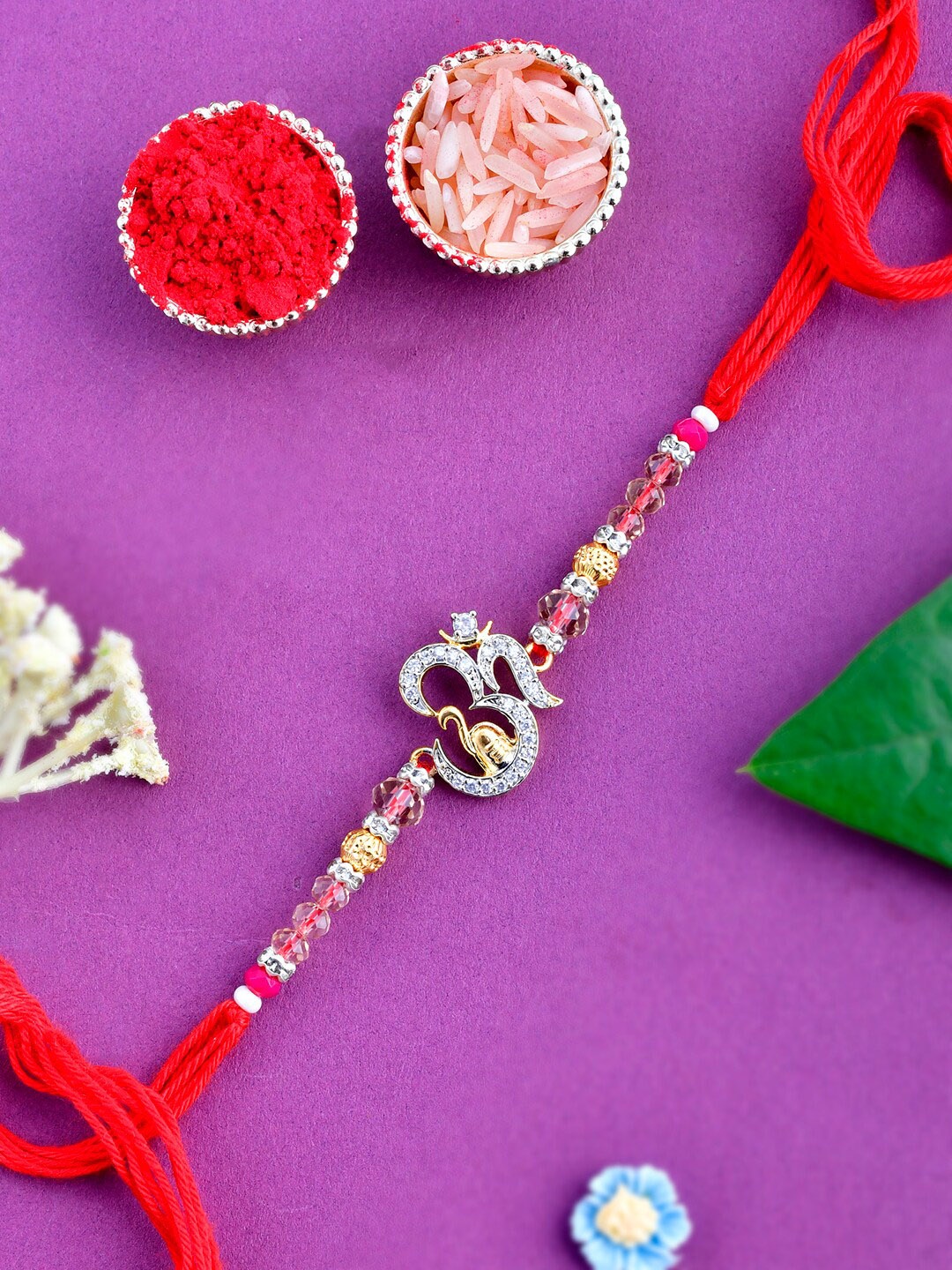 

Aapno Rajasthan American Diamond Om Charm Rakhi, Red