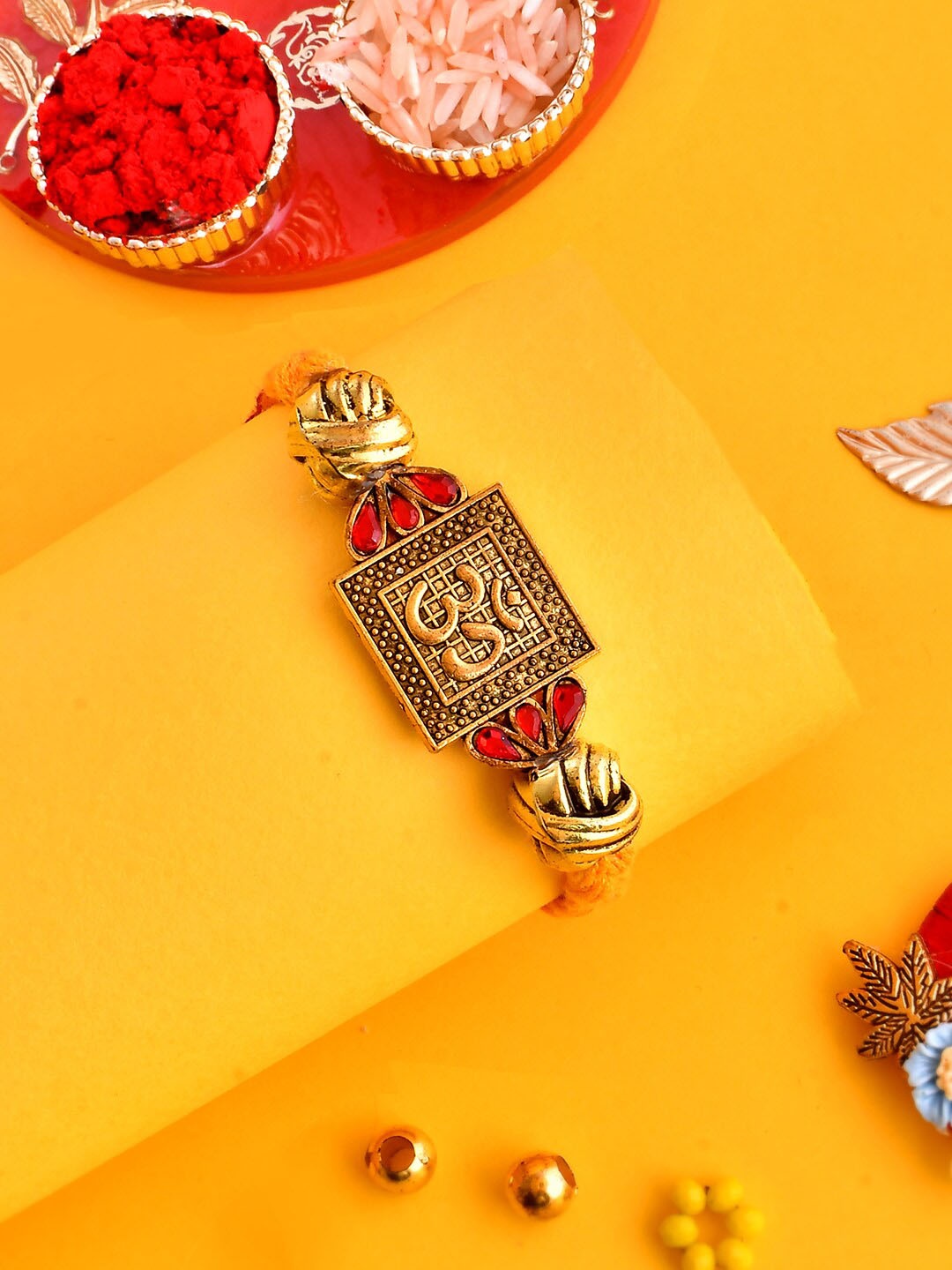 

Aapno Rajasthan Gold-Plated Stone-Studded OM Rakhi