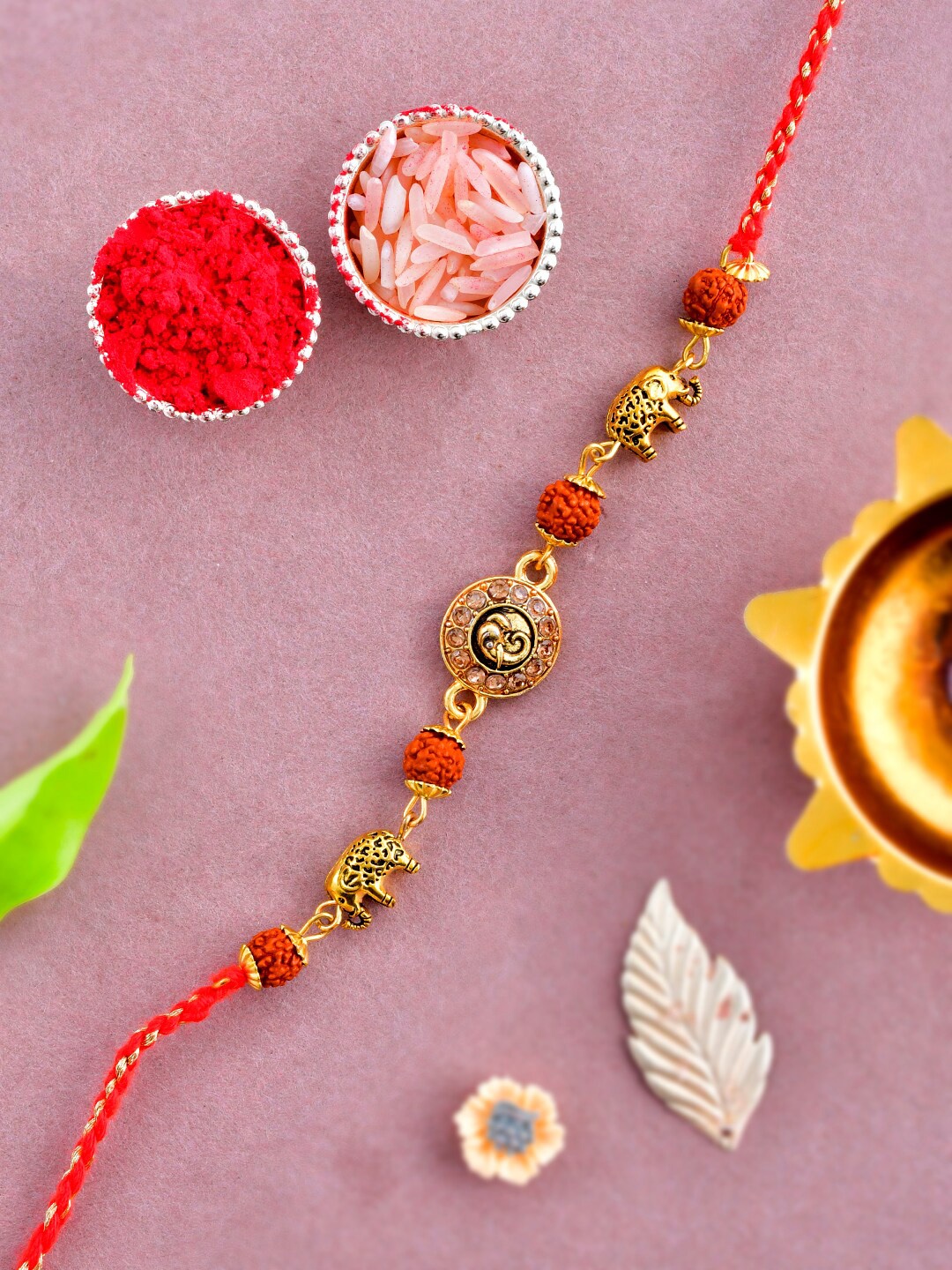 

Aapno Rajasthan Men Beaded Thread Rakhi With Roli Chawal & Greeting Card, Gold