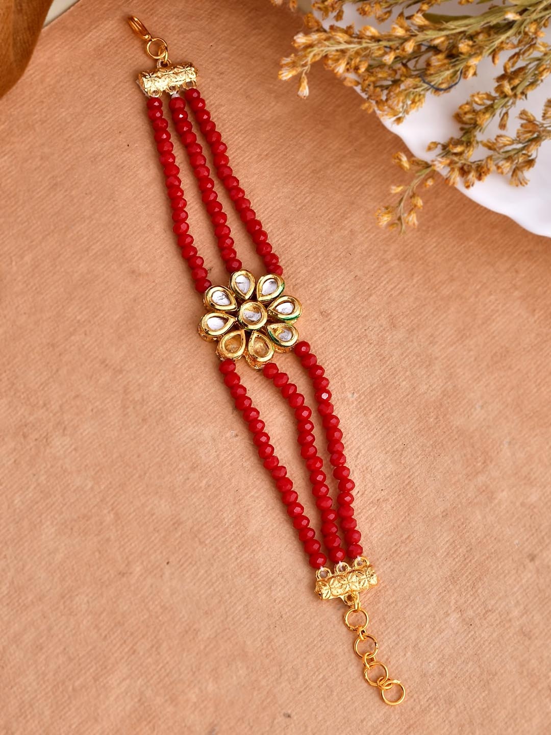 

Silvermerc Designs Women Stone Studded & Beaded Charm Bracelet Rakhi, Gold