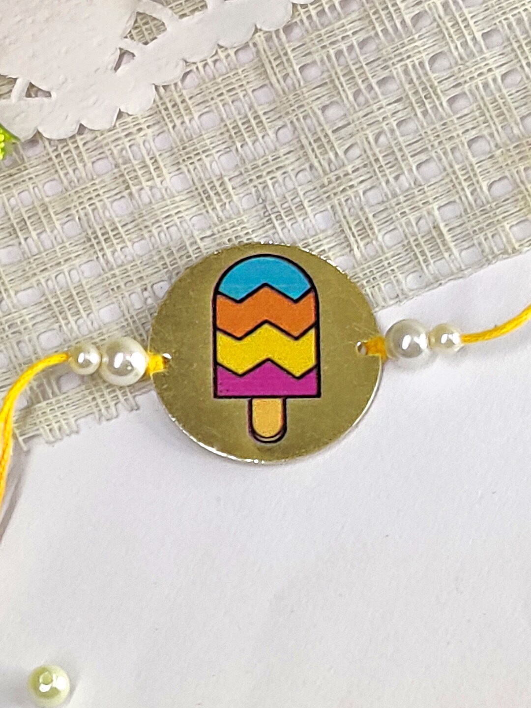 

The Magic Wand Kids Pearl Beaded Round Charm Rakhi, Yellow