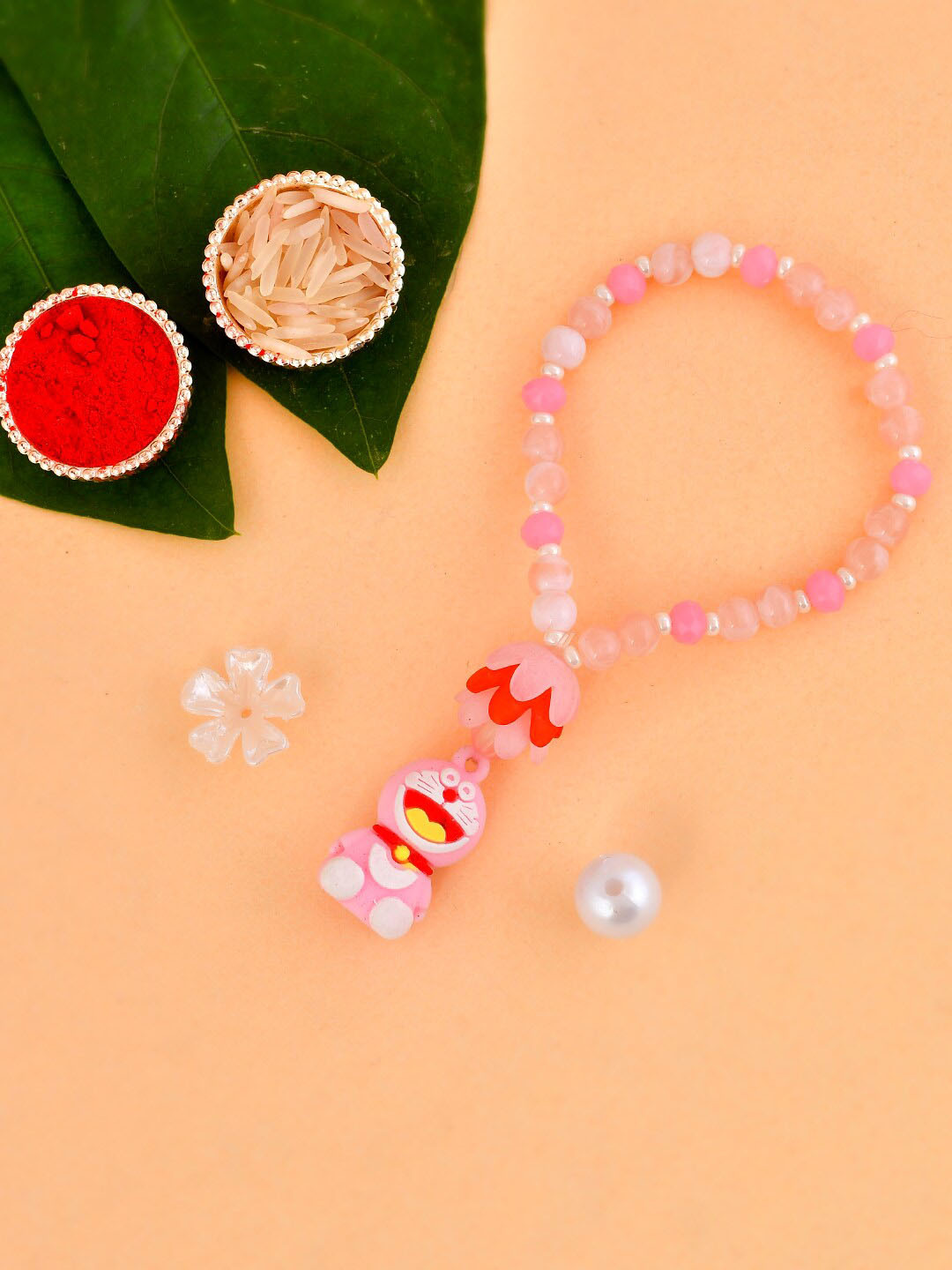 

Aapno Rajasthan Kids Set Of 3 Pastel Beaded Funky Doremon Rakhi Gift Set, Pink