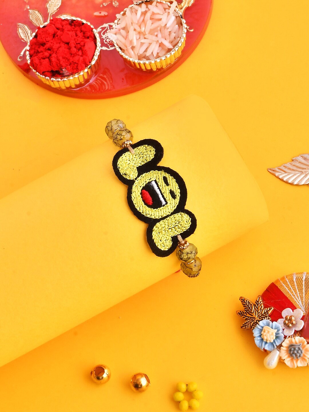 

Aapno Rajasthan Unisex Knitted LOL Joyful Beaded Rakhi Gift Set., Yellow