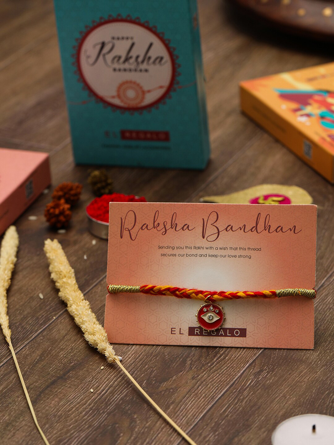 

EL REGALO Evil Eye Charm Thread Rakhi With Roli Chawal & Greeting Card, Red