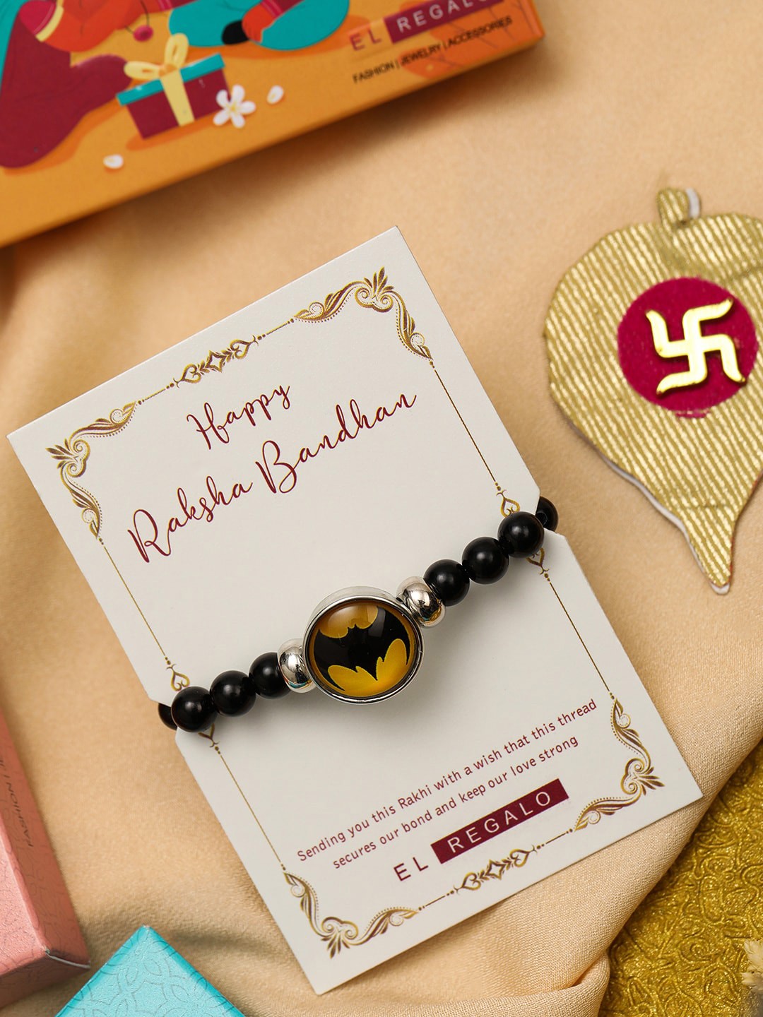 

EL REGALO Batman Charm & Beaded Rakhis With Roli Chawl & Card Gift Set Box, Black