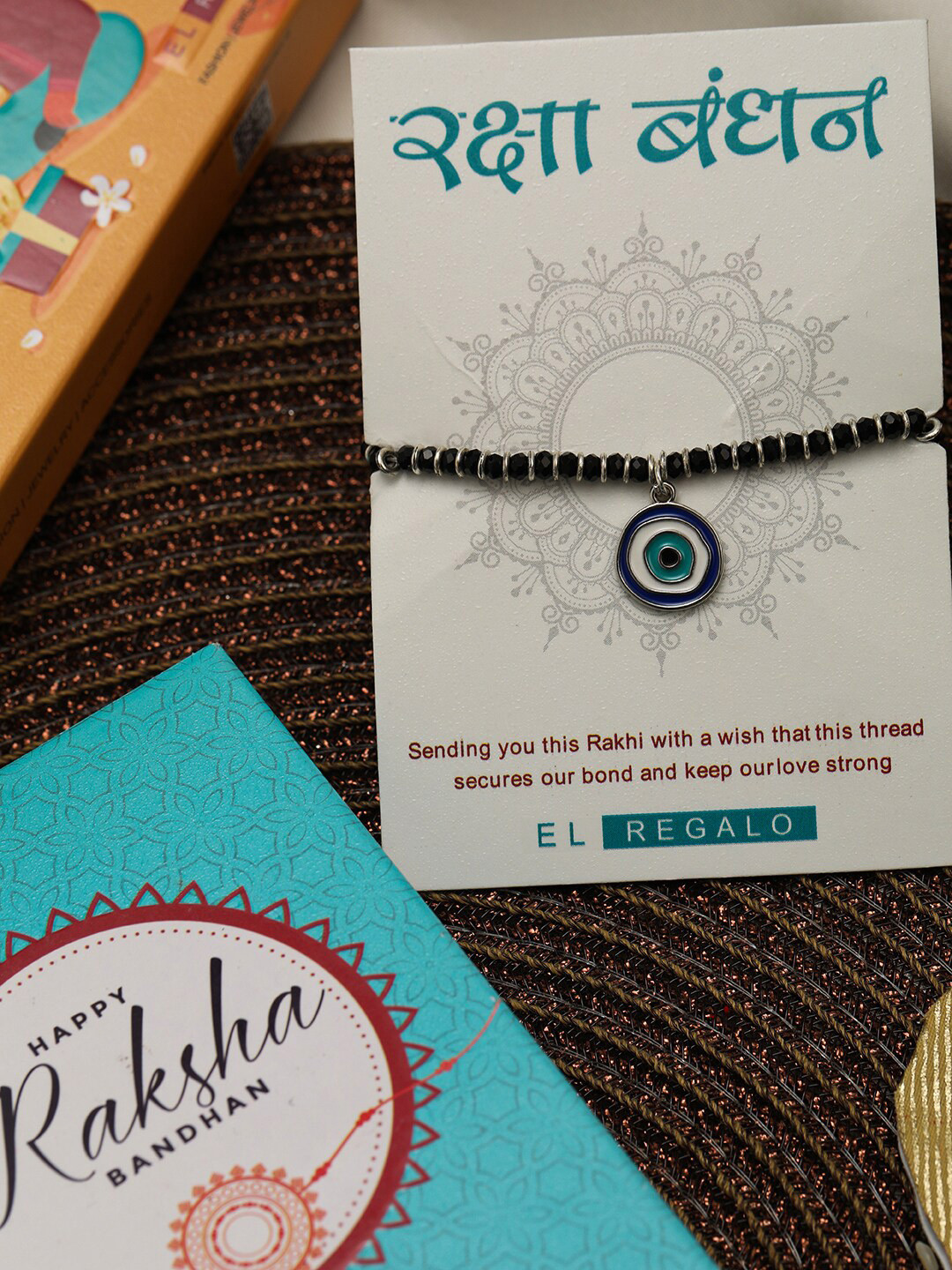

EL REGALO Kids Set Of 2 Evil Eye & Rainbow Charm Rakhi With Roli Chawl & Card Gift Set Box, Blue