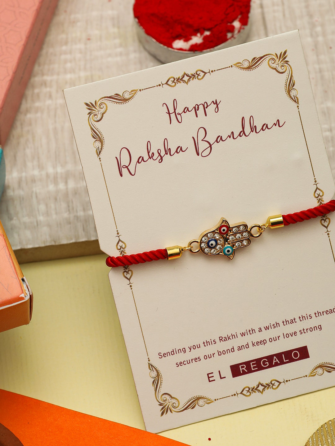 

EL REGALO Men Evil Eye & Hamsa Hand Thread Rakhi With Roli Chawal & Greeting Card, Gold