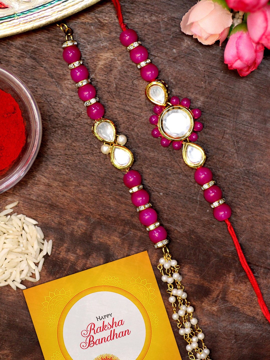 

KARATCART Set of 2 Gold-Plated Rakhi For Bhaiya & Bhabhi With Roli Chawal & Greeting Card, Pink