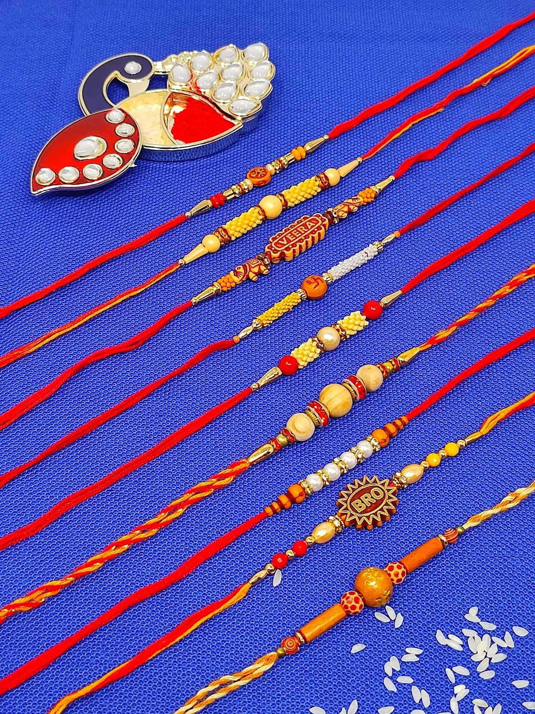 

CRAYTON Set Of 9 Beaded Rakhis with Roli Chaval Holder, Red