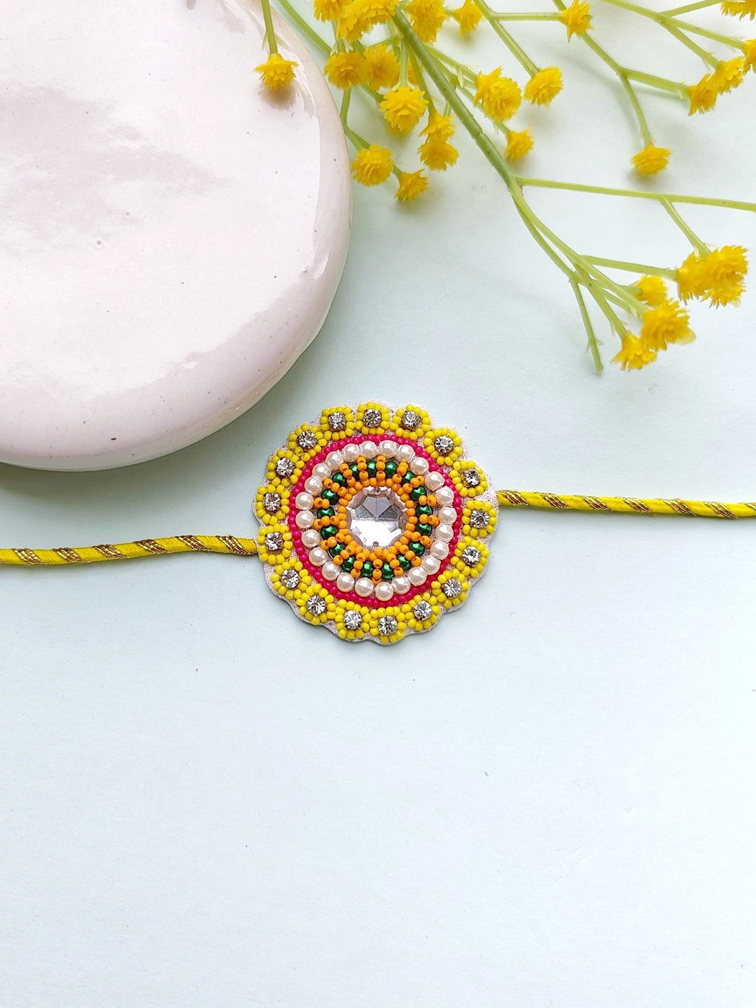 

Crunchy Fashion Beaded Flower Charm Thread Rakhi, Yellow