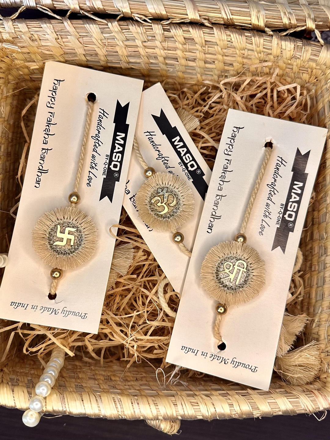 

MASQ Men Set Of 3 Shree Swastik & Om Rakhi With Roli Chawal & Moli, Beige